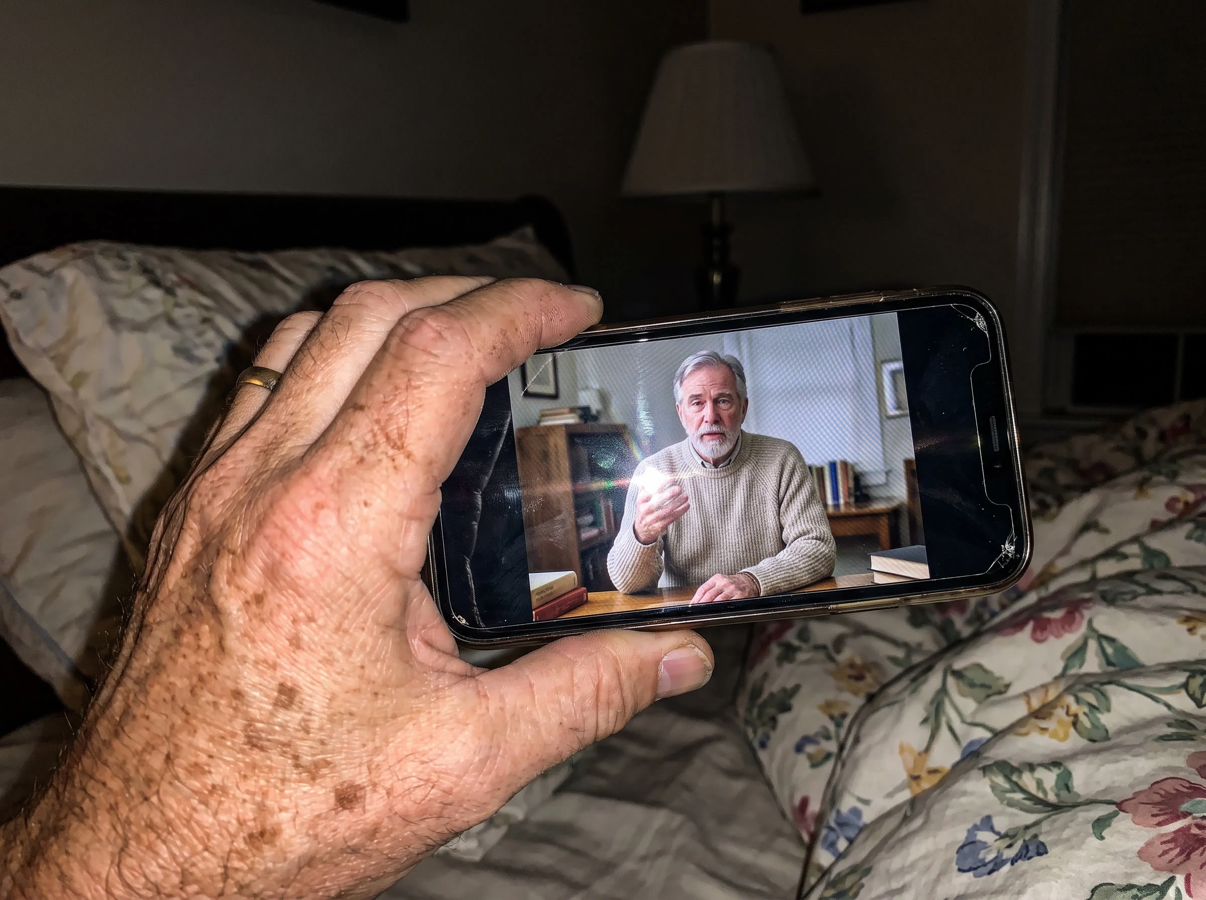 Unnamed researcher on Walt's phone screen in his hand, moiré/glare